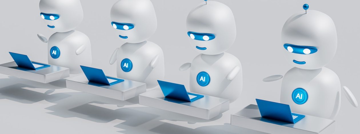 a group of white robots sitting on top of laptops