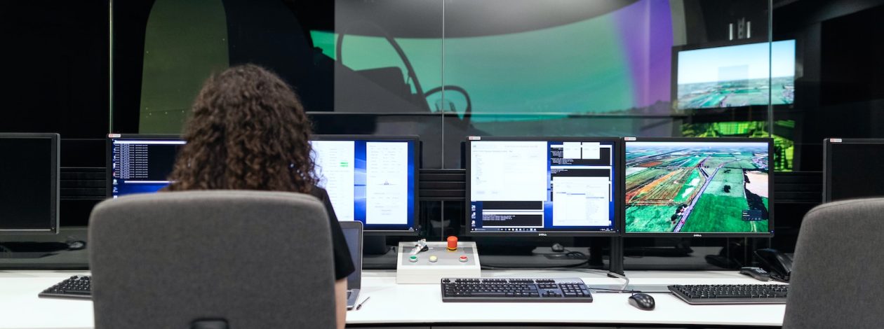 woman sitting on black office rolling chair in front of computer monitor